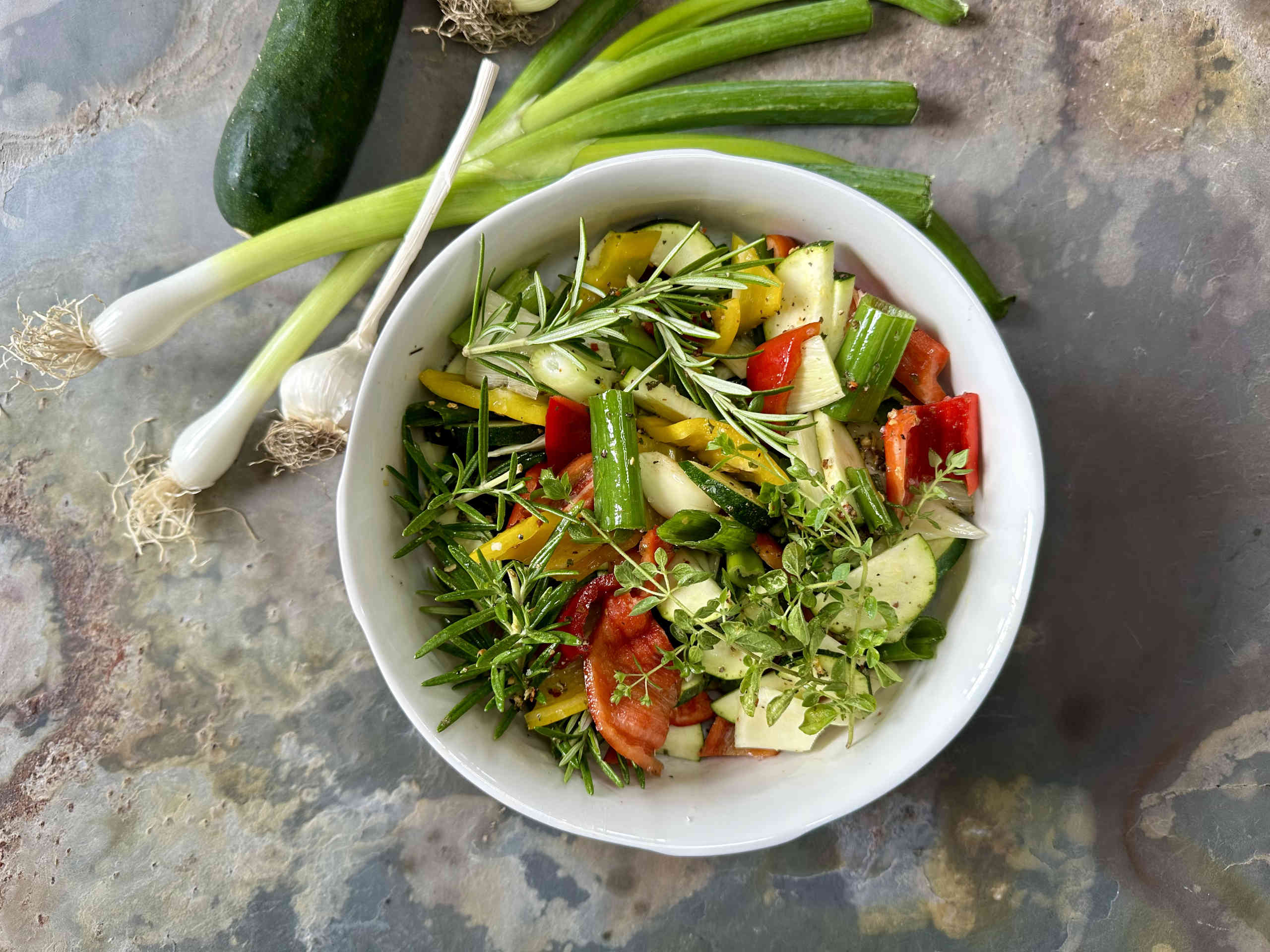 Colorful oven-baked vegetables with fresh herbs